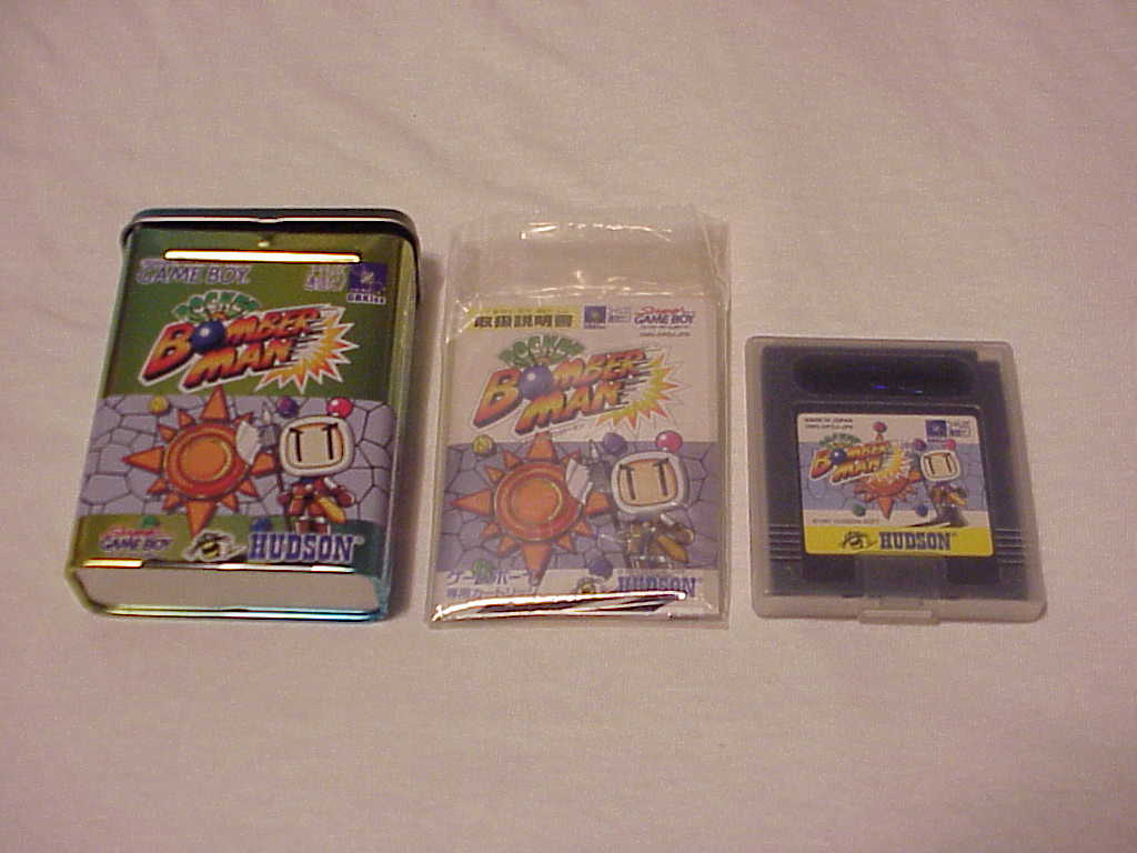 Pocket Bomberman tin, manual, and cartridge